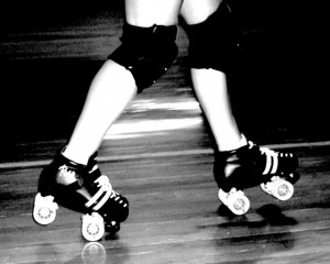 A roller derby skaters popping a wheelie